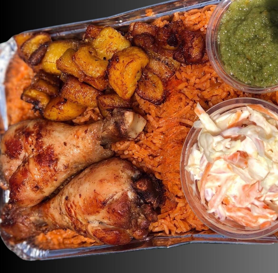 Jollof rice with chicken ,sauce,fried plantain and salad
