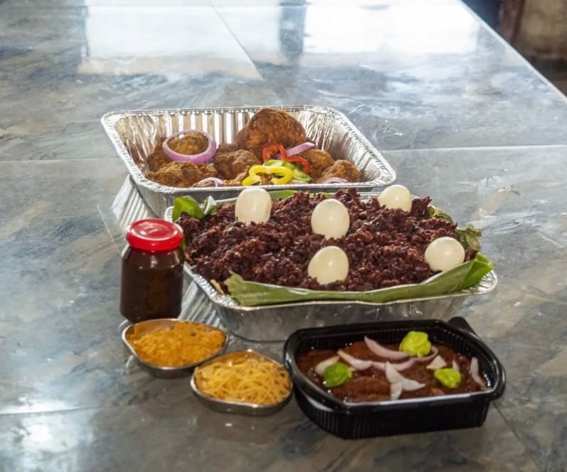 Waakye with egg,shito,stew, chicken,salad, fish/sausage